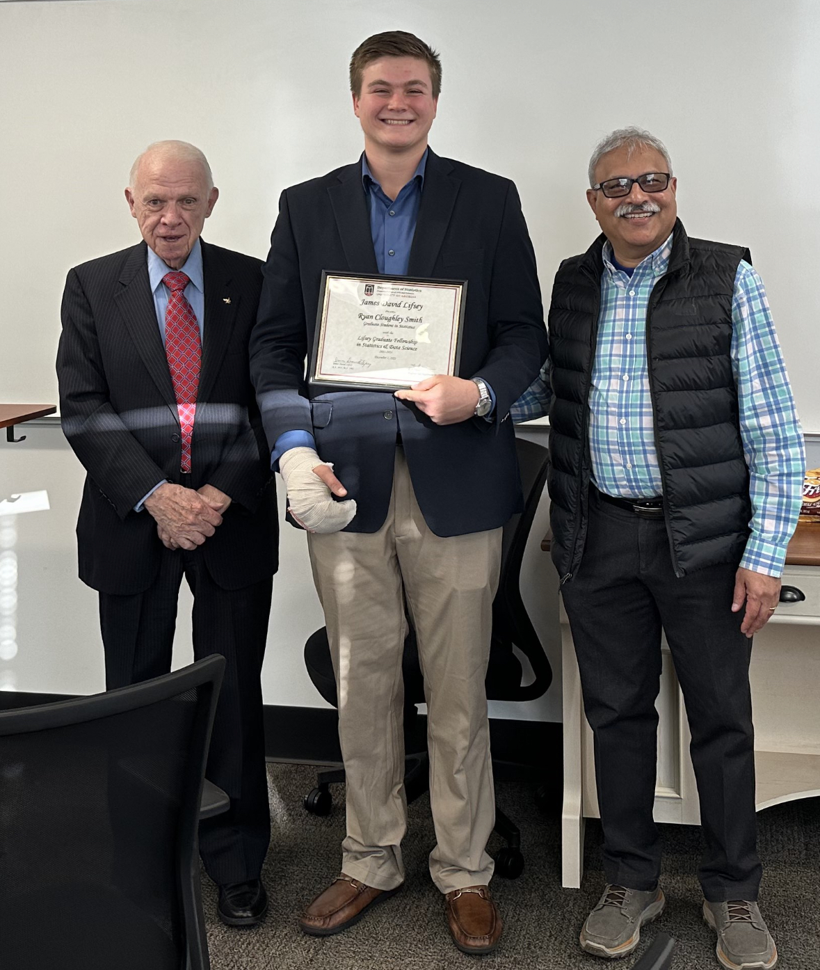 Mr Lifsey presenting Ryan Smith with his fellowship certificate with Department Head TN Sriram