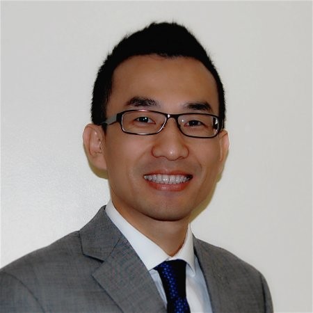 Dr. Fei Liu wearing glasses and smiling at the camera
